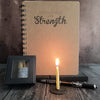 Strength candle bundle with lit candle