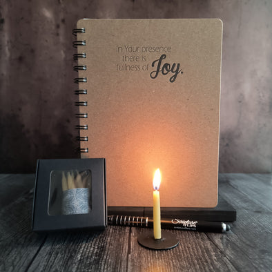 Joy candle bundle with lit 20 minute candle on a stand